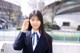 A woman in a school uniform posing for a picture.