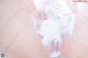 A close up of a woman's breast covered in milk.