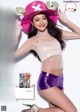 A woman in a pink hat and purple shorts posing for a magazine.